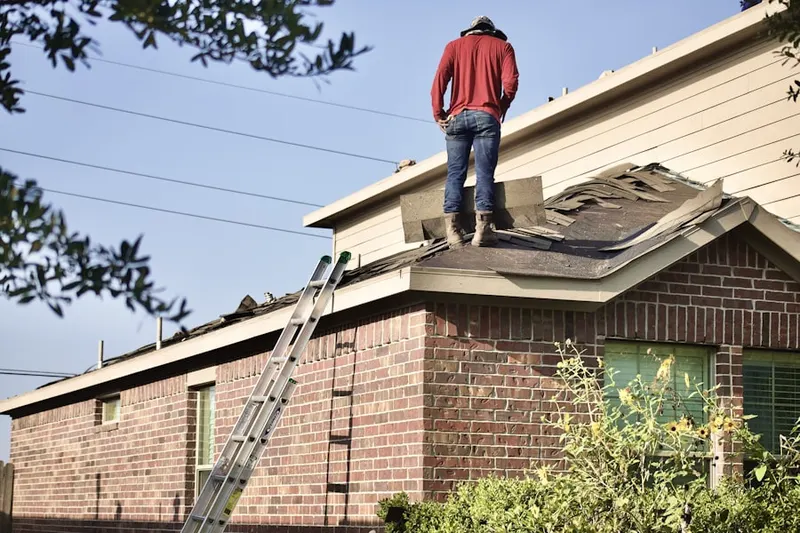 Professional roofer working on a residential roof in Marnett